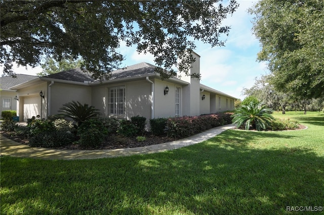 view of property exterior featuring a garage and a yard