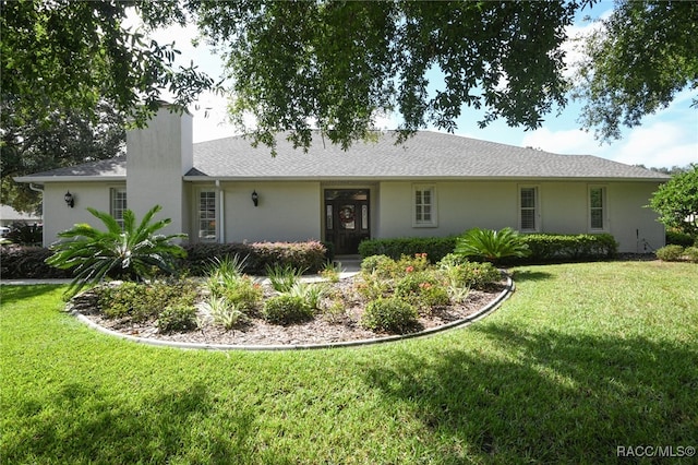 ranch-style home featuring a front lawn