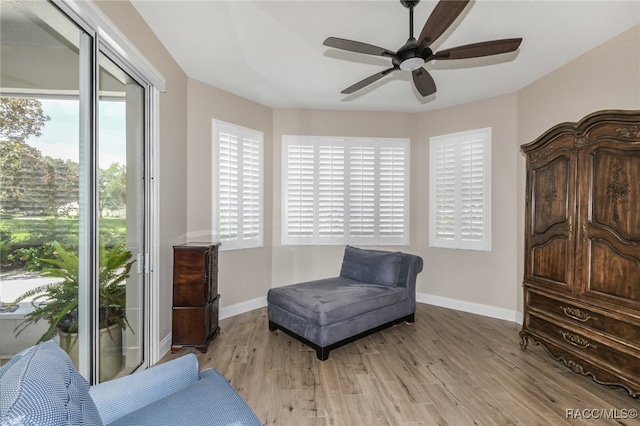 living area with ceiling fan and light wood-type flooring