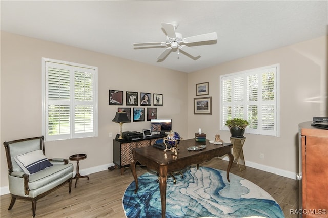 home office with wood-type flooring and ceiling fan