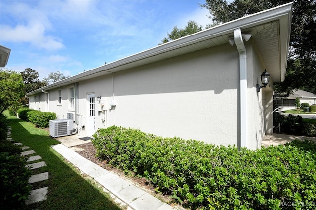 view of side of home featuring central AC unit