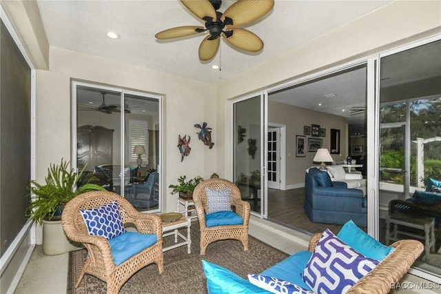 sunroom featuring ceiling fan