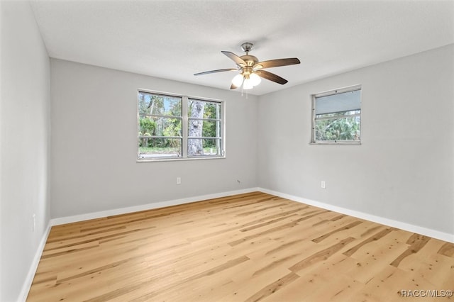 empty room featuring light wood-type flooring and ceiling fan