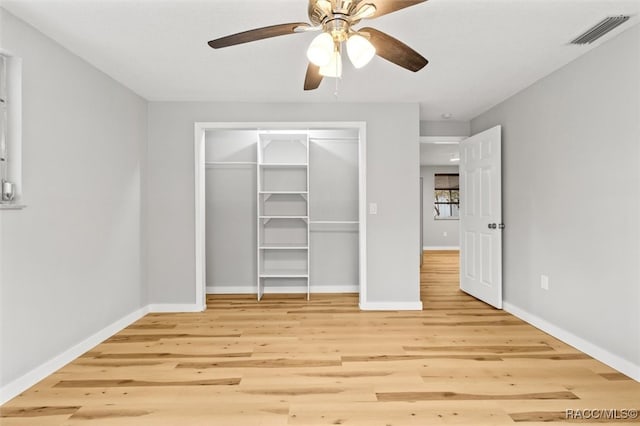 unfurnished bedroom with ceiling fan, a closet, and light hardwood / wood-style flooring