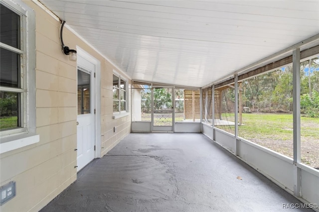 unfurnished sunroom with a wealth of natural light and lofted ceiling