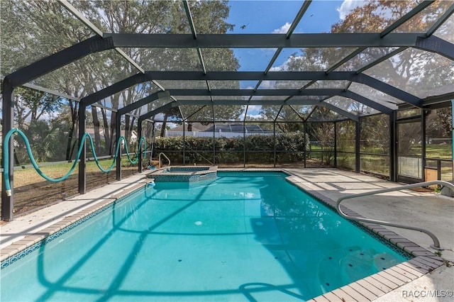 view of swimming pool featuring a lanai, an in ground hot tub, and a patio