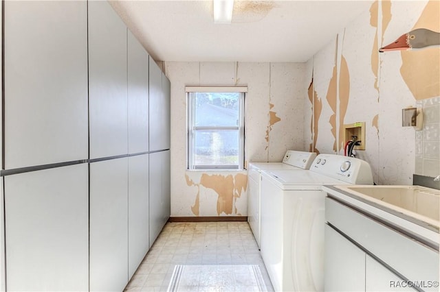 washroom with cabinets and independent washer and dryer