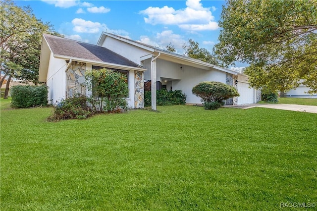 single story home with a garage and a front lawn