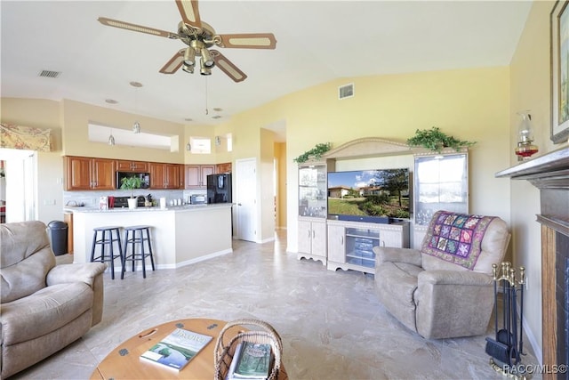 living room with ceiling fan and lofted ceiling