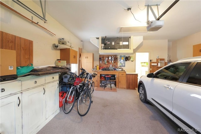 garage with a workshop area and a garage door opener