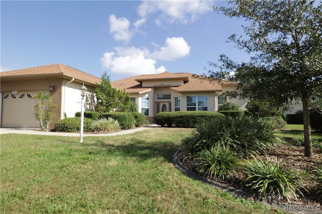 view of front of house with a front lawn and a garage