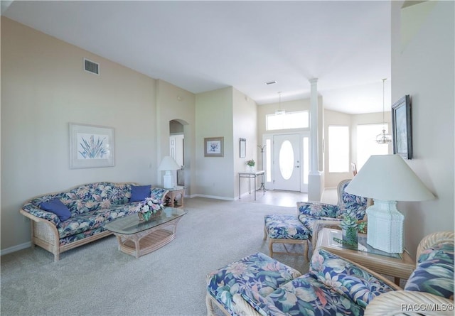 living room featuring carpet and a towering ceiling