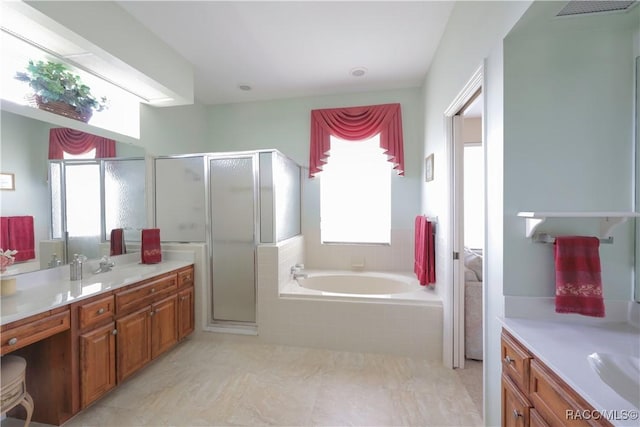 bathroom featuring plus walk in shower, vanity, and tile patterned flooring