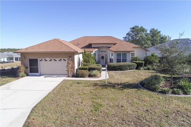 view of front of home with a garage and a front lawn