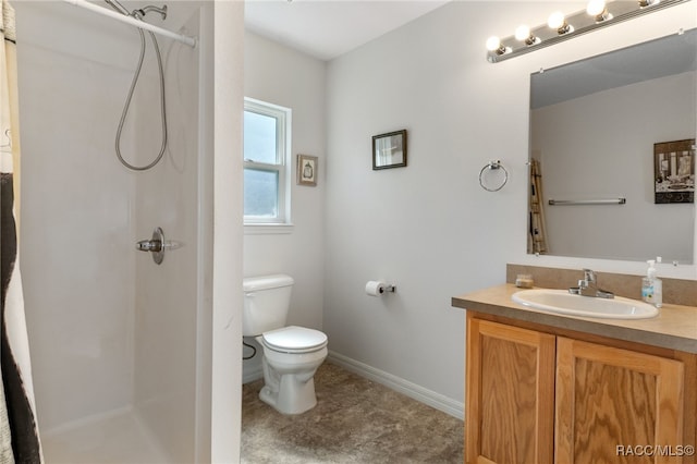 bathroom with a shower, vanity, and toilet