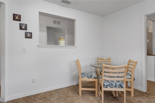 dining space featuring carpet