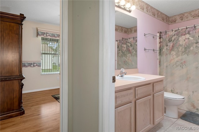 bathroom with vanity, a shower with curtain, toilet, a textured ceiling, and wood-type flooring