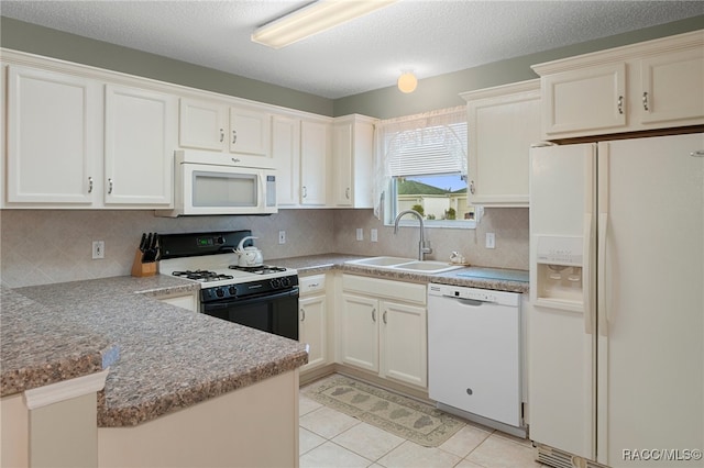 kitchen featuring white cabinetry, sink, kitchen peninsula, a textured ceiling, and white appliances