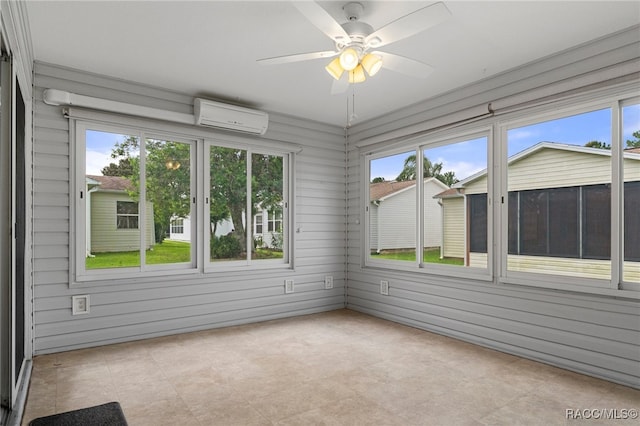 unfurnished sunroom featuring a wall mounted air conditioner, plenty of natural light, and ceiling fan