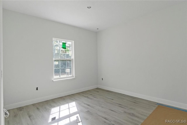 spare room with light hardwood / wood-style floors