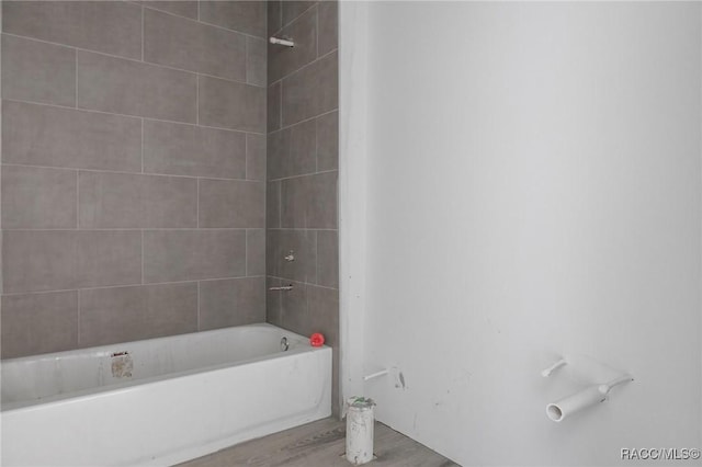 bathroom featuring hardwood / wood-style flooring and tiled shower / bath