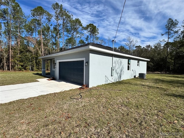 garage featuring a yard and cooling unit