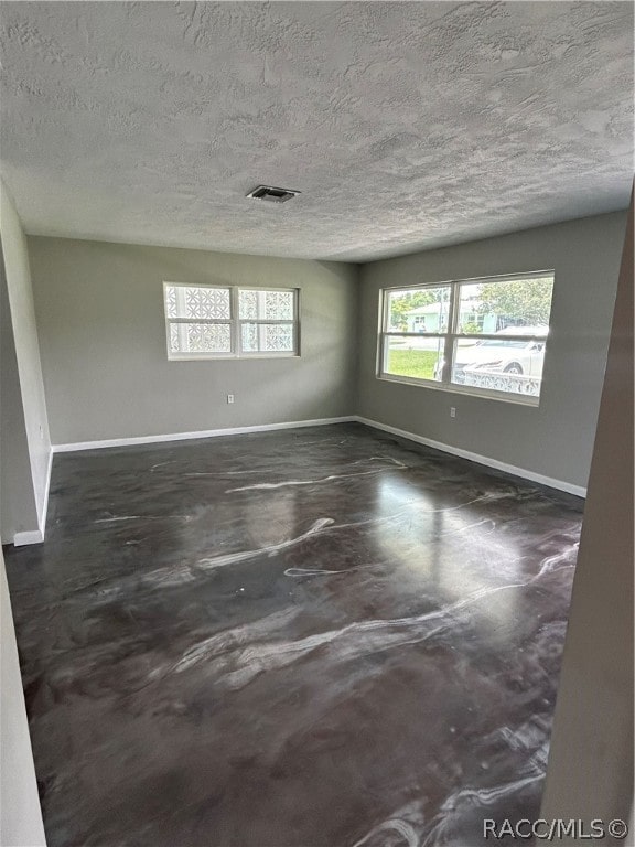 empty room with a textured ceiling