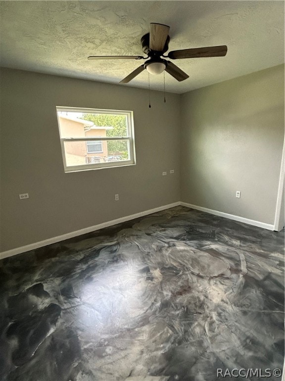 empty room with a textured ceiling and ceiling fan