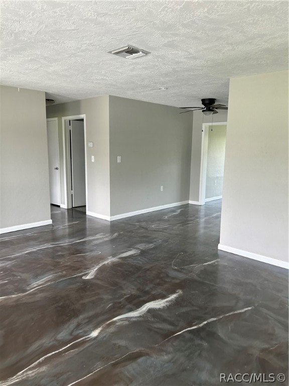 unfurnished room featuring ceiling fan and a textured ceiling