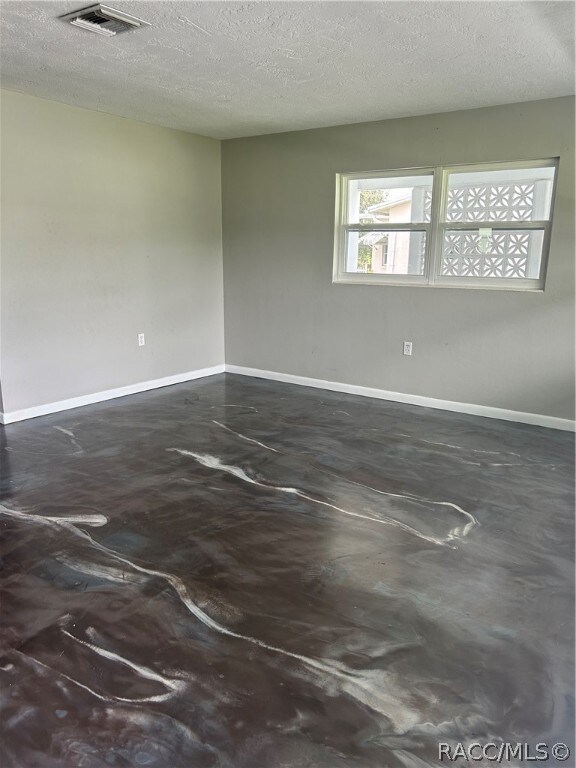 empty room featuring a textured ceiling