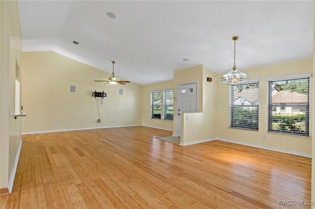 unfurnished living room featuring ceiling fan, lofted ceiling, and light hardwood / wood-style floors