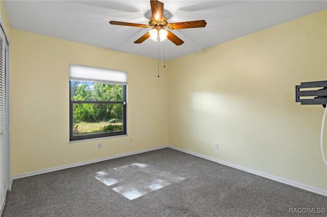 empty room with carpet flooring and ceiling fan