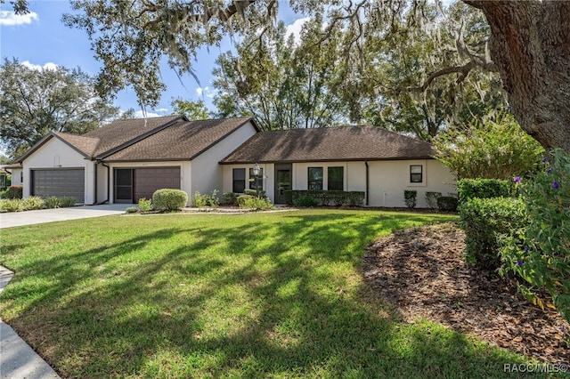 single story home featuring a garage and a front lawn