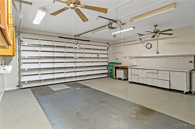 garage featuring ceiling fan and a garage door opener