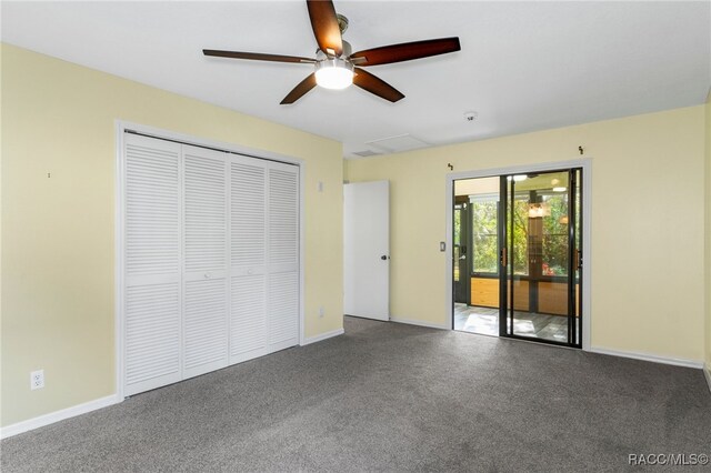 unfurnished bedroom with ceiling fan, carpet flooring, and a closet