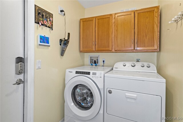 laundry room featuring cabinets and separate washer and dryer