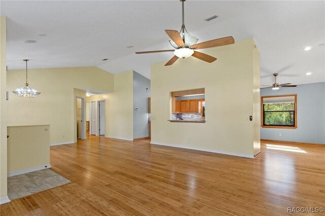 unfurnished living room with ceiling fan, high vaulted ceiling, and light wood-type flooring