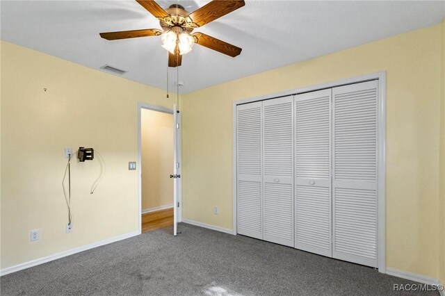 unfurnished bedroom featuring ceiling fan, carpet flooring, and a closet