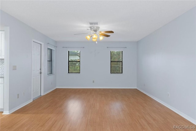 unfurnished room featuring ceiling fan and light hardwood / wood-style floors