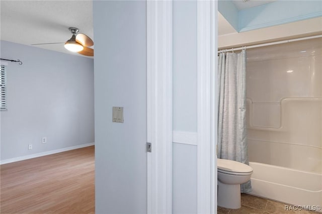 bathroom with hardwood / wood-style floors, shower / bath combo, and toilet