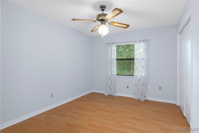 unfurnished room featuring light hardwood / wood-style flooring and ceiling fan