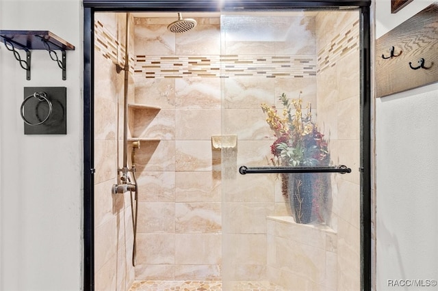 bathroom featuring a shower with shower door