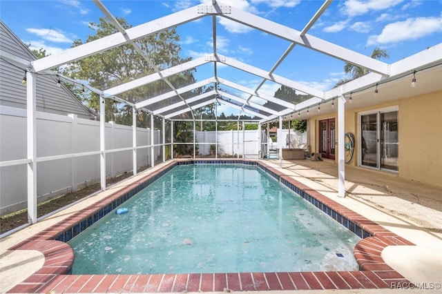 view of pool with a patio area and a lanai