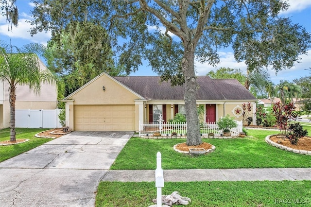 ranch-style home featuring a front lawn, a porch, and a garage