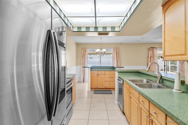 kitchen featuring stainless steel appliances, sink, light tile patterned floors, an inviting chandelier, and hanging light fixtures