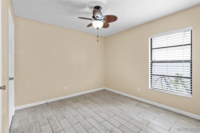 unfurnished room with a textured ceiling, light hardwood / wood-style flooring, and ceiling fan