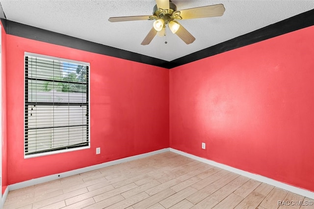 spare room with a textured ceiling, light hardwood / wood-style floors, and ceiling fan