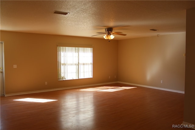 unfurnished room featuring ceiling fan, a textured ceiling, and hardwood / wood-style flooring