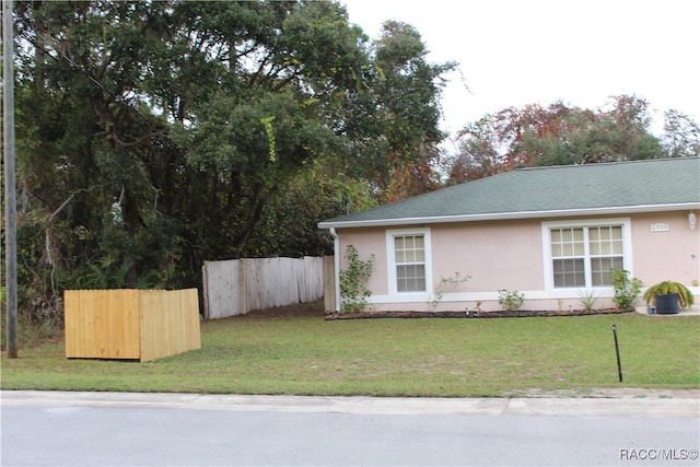 view of side of property with a lawn