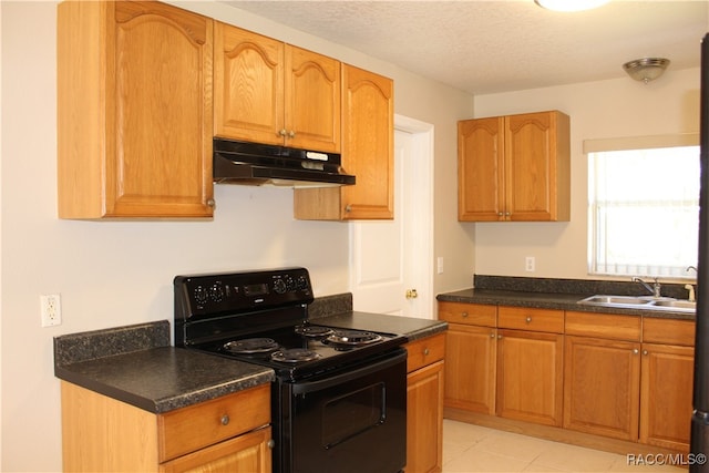 kitchen with light tile patterned floors, a textured ceiling, black electric range oven, and sink